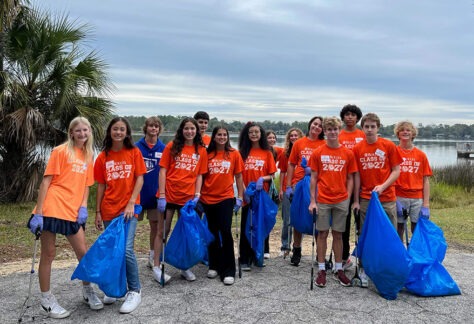 Studentswithtrashbagscleaningupriverareas